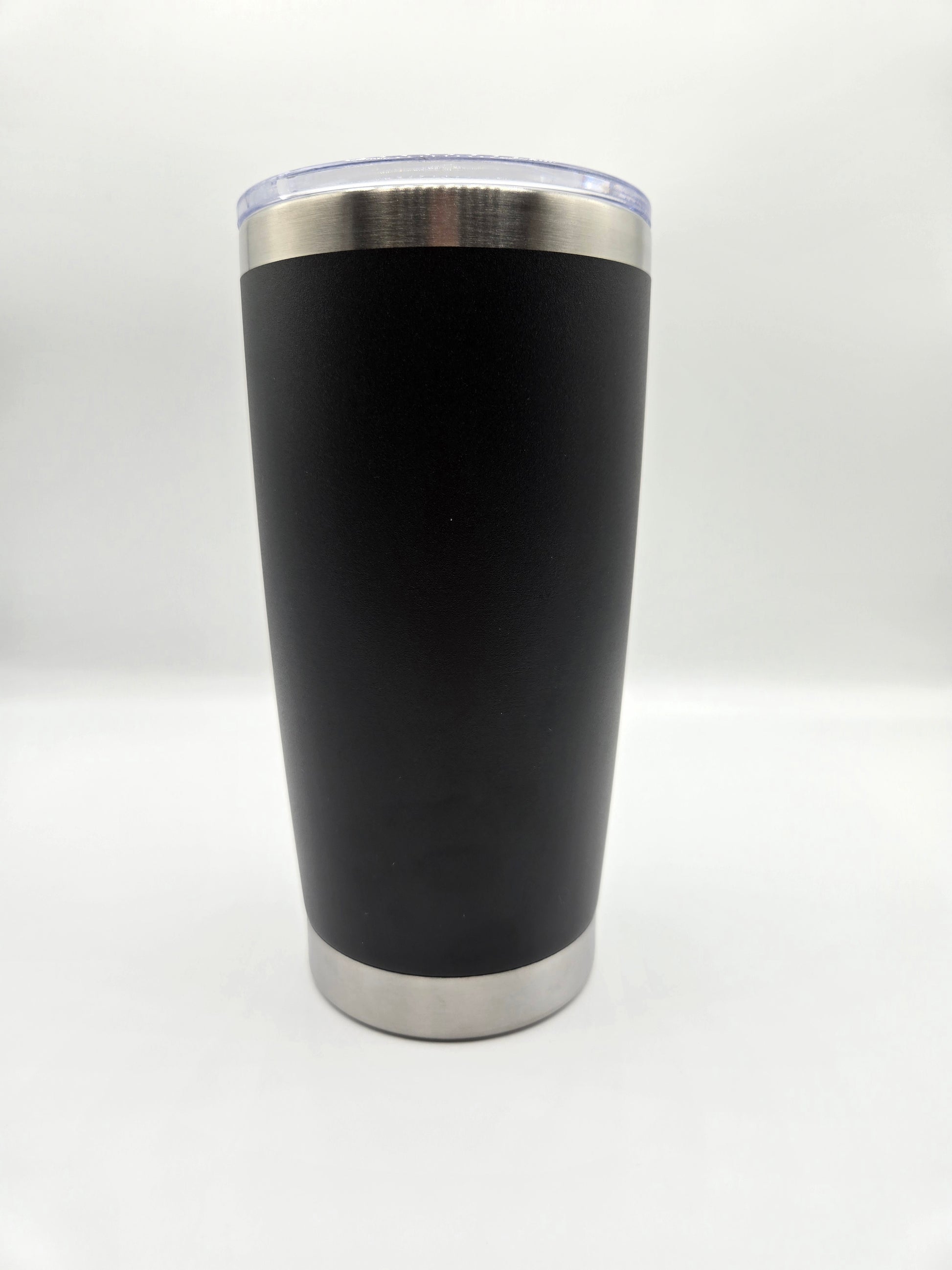 Black tumbler with silver rim on a white background
